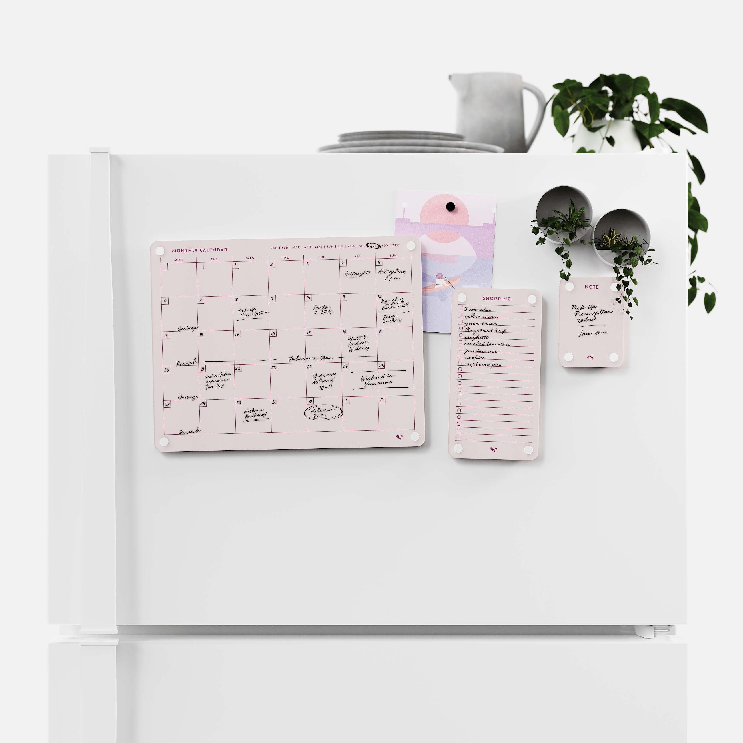 Linen white monthly calendar, shopping list and note board magnetised to a white fridge door